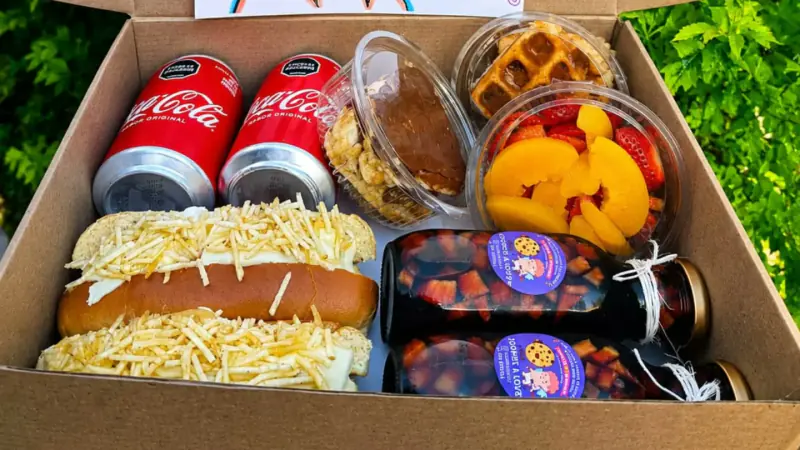 Caja de regalo con sánduches, frutas, waffle y gaseosas